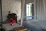 The main bedroom, looking to the entrance from the stairs - the Village house, Chora, Patmos