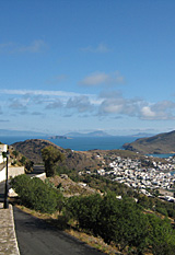 View northwards from Chora, the old town, to Skala, the port of Patmos, Greece, to the islands beyond
