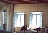 The main bedroom with its west facing windows and exit onto the roof terrace, the Village house, Chora The main bedroom with its west facing windows and exit onto the roof terrace, the Village house, Chora