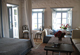 The main bedroom with its west facing windows and exit onto the roof terrace, the Village house, Chora, Patmos